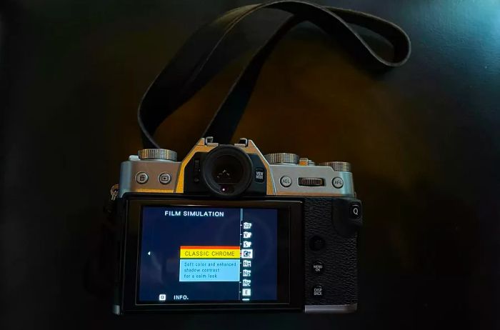 Fujifilm X-T30 II positioned horizontally on a black background, screen facing up