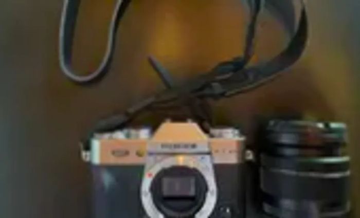 The Fujifilm X-T30 II positioned on its side on a black surface