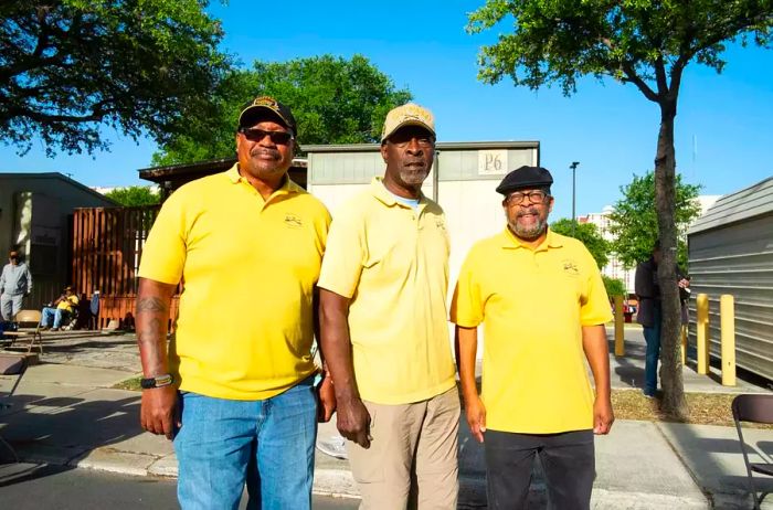 Bexar County Buffalo Soldiers, dressed in yellow shirts, manage a designated seating area for the Battle of Flowers Parade in San Antonio, Texas.