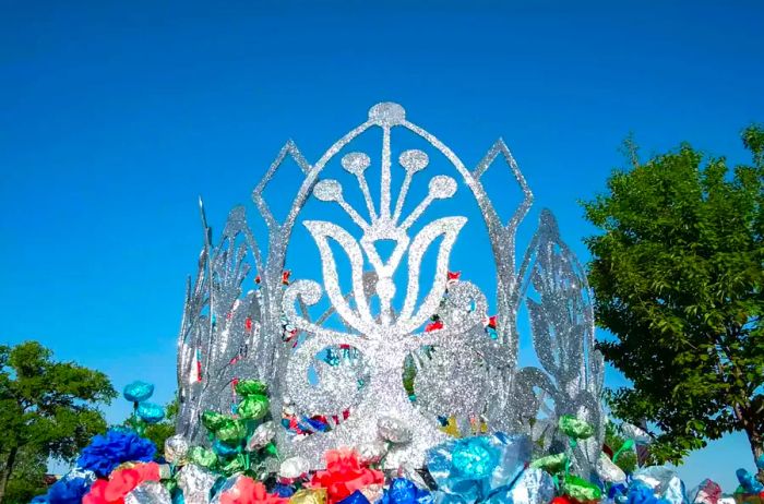 The parade float crown sparkles brilliantly in the sunlight.