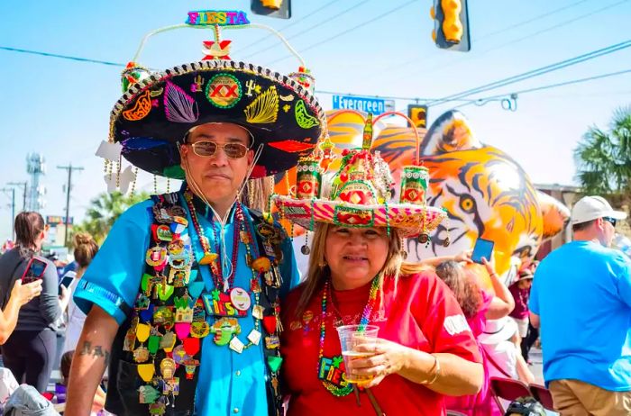 A couple dressed in festive attire enjoys the parade atmosphere.