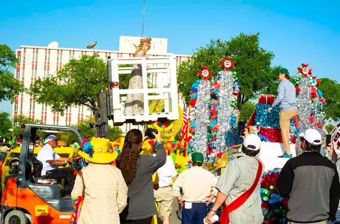 A princess is helped onto her float.