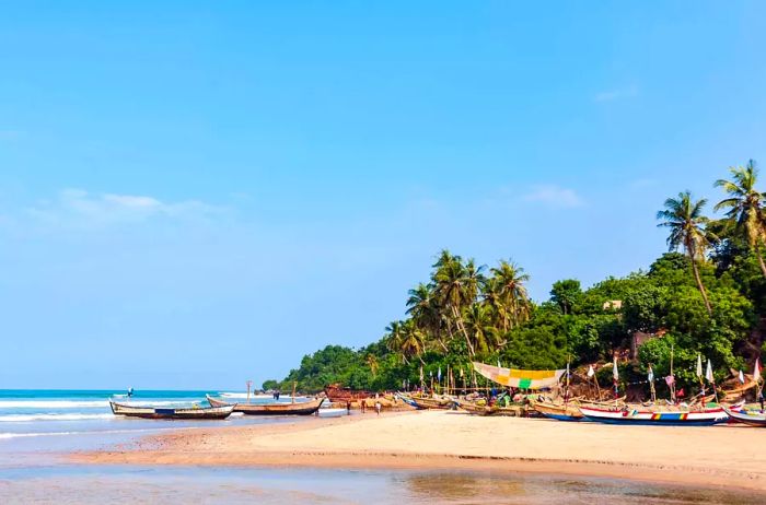 A beachside village with traditional wooden fishing boats along the Atlantic Ocean in Accra, Ghana