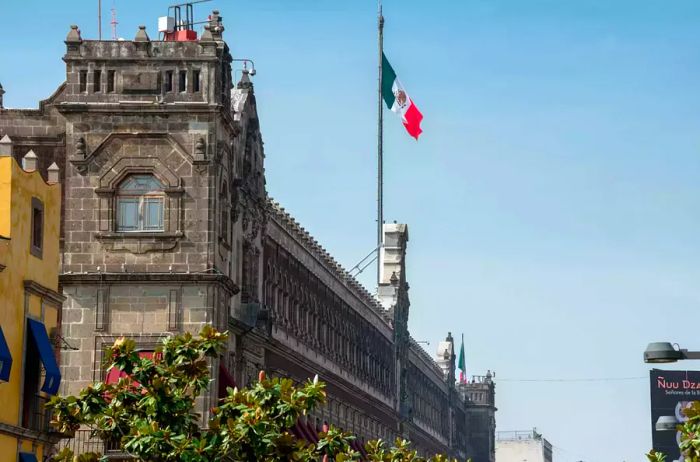 The Mexican flag proudly waves atop the National Palace.