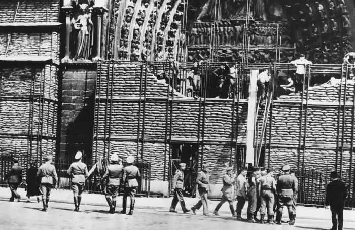 Removal of sandbag barriers from the facade of Notre Dame during German-occupied Paris, 1940.