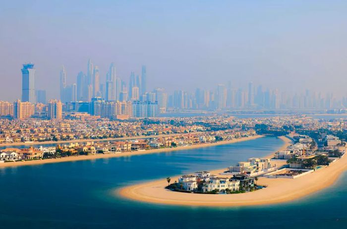 Aerial panoramic views showcase the luxurious Palm Jumeirah Islands in Dubai, complete with upscale hotels, residences, shopping malls, and water parks.