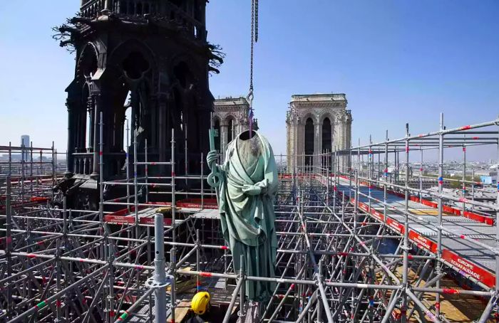 On April 11, 2019, a crane lifted a religious statue from the spire of Notre Dame cathedral in Paris, France, prior to restoration work.