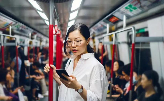 Woman using her mobile phone on public transport