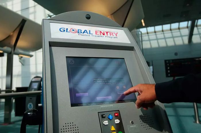 A US Customs and Border Protection officer showcases a new arrivals processing kiosk