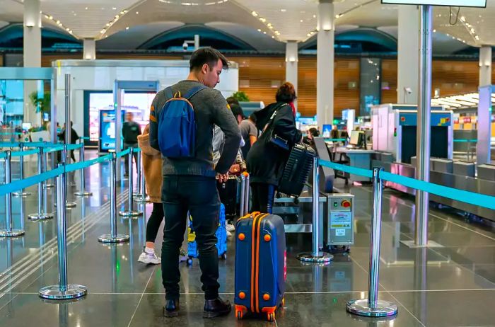 Travelers undergoing security checks at the airport