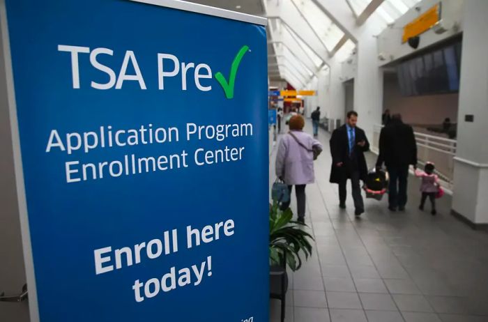 Passengers pass by a newly opened TSA PreCheck application center located in Terminal C at LaGuardia Airport.