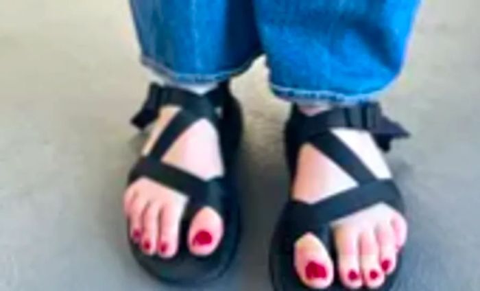 A woman is seen in Chaco Z Cloud 2 Sandals teamed with jeans