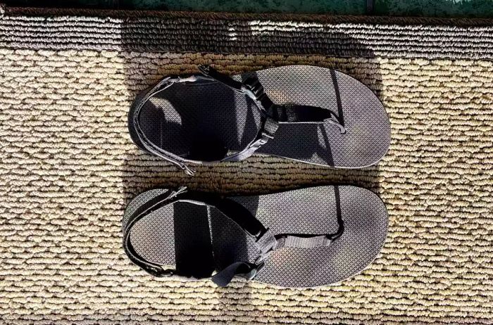 An aerial shot of the Bedrock Cairn Adventure Sandals placed on a carpet