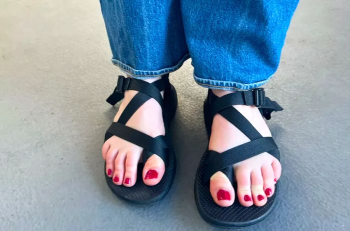 A woman is seen wearing Chaco Z Cloud 2 Sandals paired with jeans