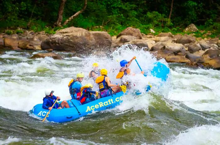 Whitewater rafting in a blue raft on the New River