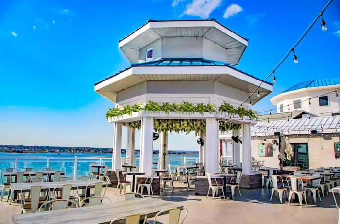 A charming gazebo perched on a terrace at a wine bar with breathtaking views of the Atlantic Ocean in Maryland.