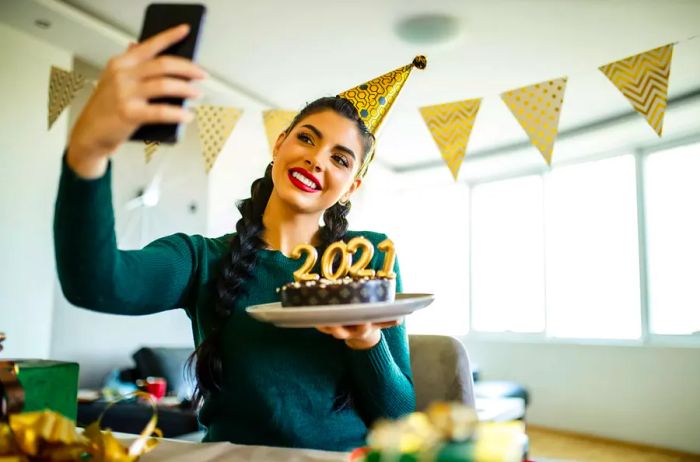 A woman video calling while preparing for New Year celebrations.