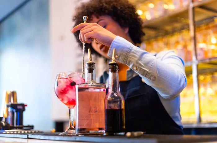 Female bartender crafting cocktails