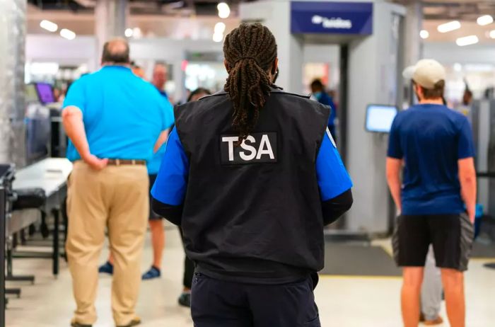 A Transportation Security Administration (TSA) officer at Hartsfield-Jackson Atlanta International Airport (ATL) in Atlanta, Georgia, US, on Monday, October 2, 2023. The FAA's oversight of federal aviation programs has been extended until December 31, as part of the temporary legislation signed by President Joe Biden on Saturday, narrowly preventing a lapse while long-term reauthorization is still mired in debates over pilot training.