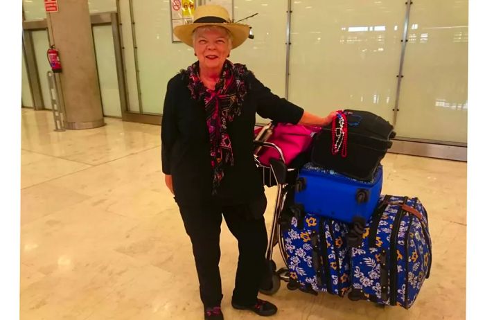 An older woman with her bags at Madrid Airport