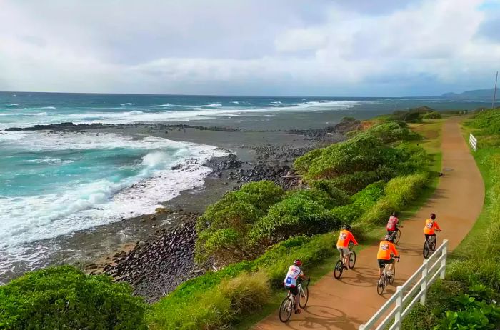 Cyclists enjoying the Ke Ala Hele Makālae Trail, Kaua‘i, Hawaii.