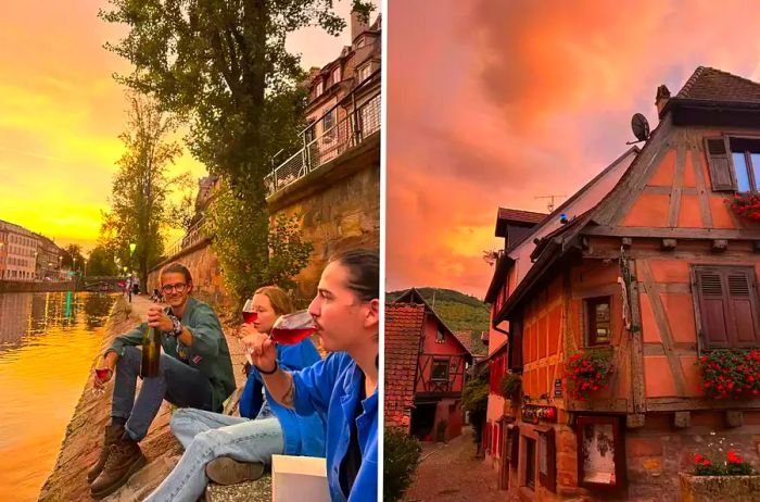 People enjoying wine by a riverside at sunset in a quaint French village.