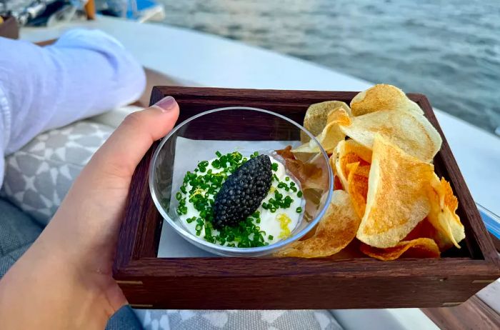 A platter of chips and caviar aboard the Aman New York Yacht.