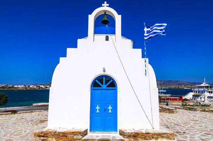 Agia Marina: A Traditional Greek Christian church with whitewashed architecture typical of the Cyclades, perched on a hill overlooking Antiparos port.