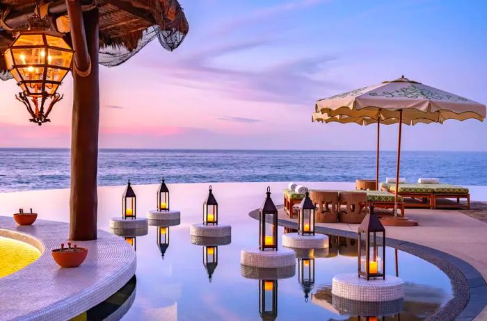 Candlelit sunset view by the pool at Waldorf Astoria Los Cabos Pedregal