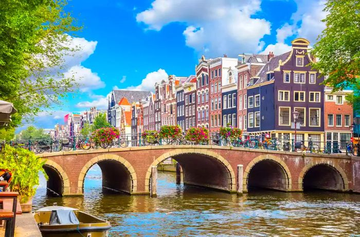 Historic houses and a bridge spanning the Amstel River in Amsterdam