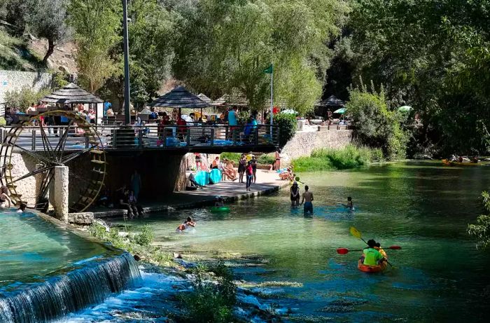 Individuals engaging in water activities along a river in Portugal.