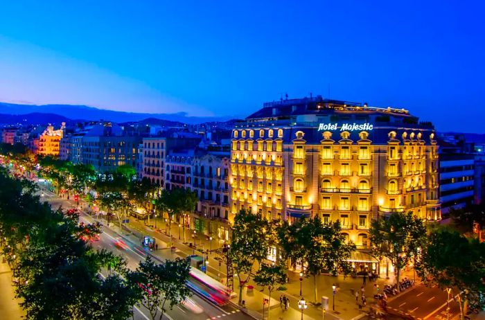 The facade of a Barcelona hotel illuminated at night