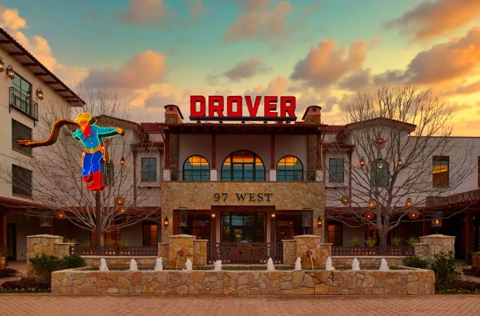 The exterior view of Hotel Drover featuring neon signage