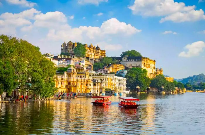 The City Palace alongside the tourist boat on Lake Pichola.