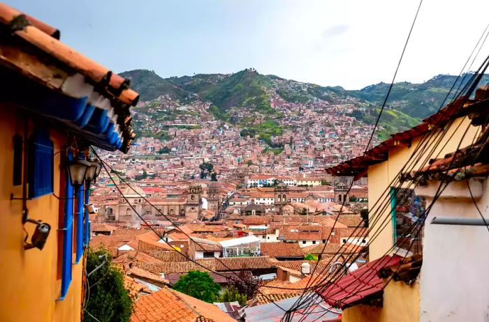 A view of Cusco's cityscape framed by surrounding architecture.