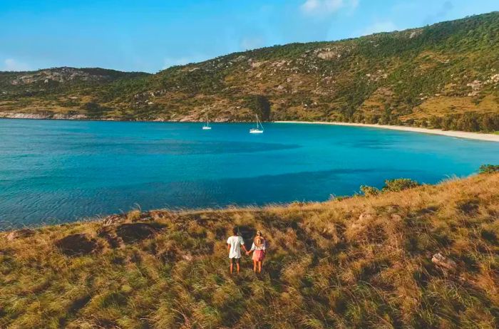 A couple gazing out from the shore of a Great Barrier Reef Island