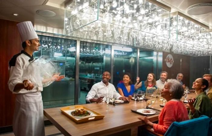 a group of people enjoying a dinner at the chef’s table