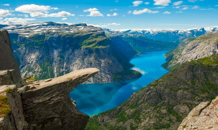 A towering rock formation overlooking a fjord in Norway.