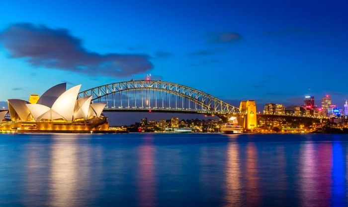 The Sydney Opera House and city skyline illuminated at night