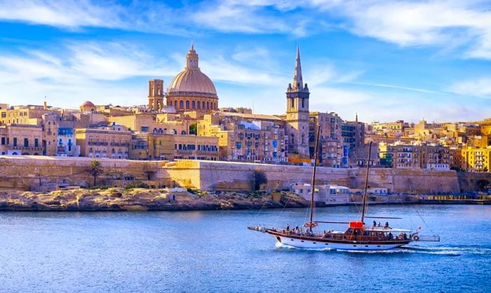 A lone boat sailing off the coast of Malta