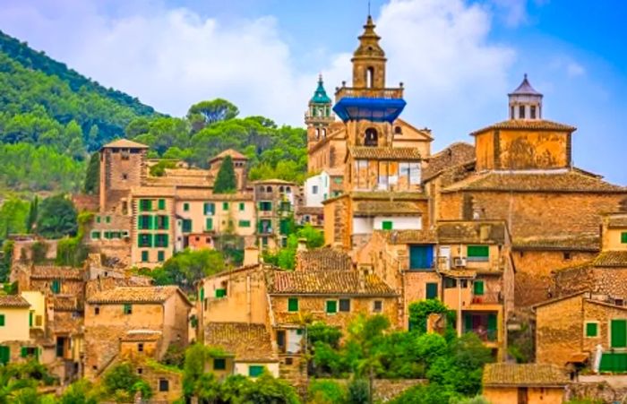 a panoramic view of the tall buildings in Valldemossa, a historic village located in Palma de Mallorca