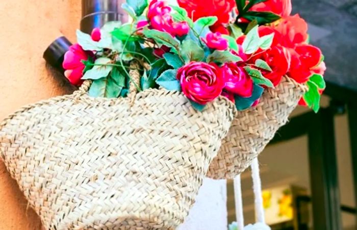 coffa bags displayed on a wall adorned with pink and red flowers