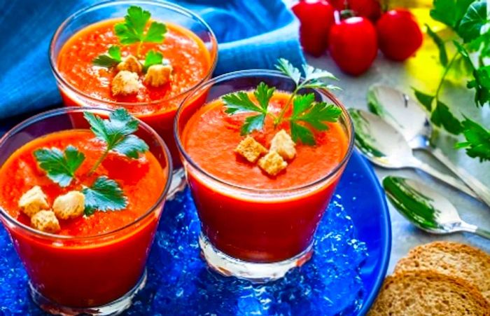 three glasses filled with chilled tomato soup