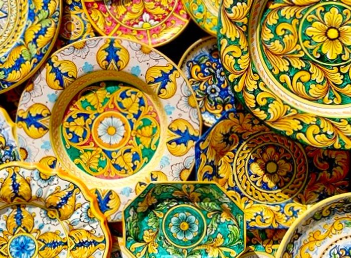 a collection of ceramic Italian plates from a market