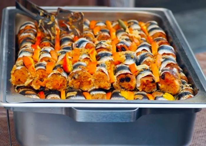 A large platter of beccafico-style sardines, ready to be enjoyed