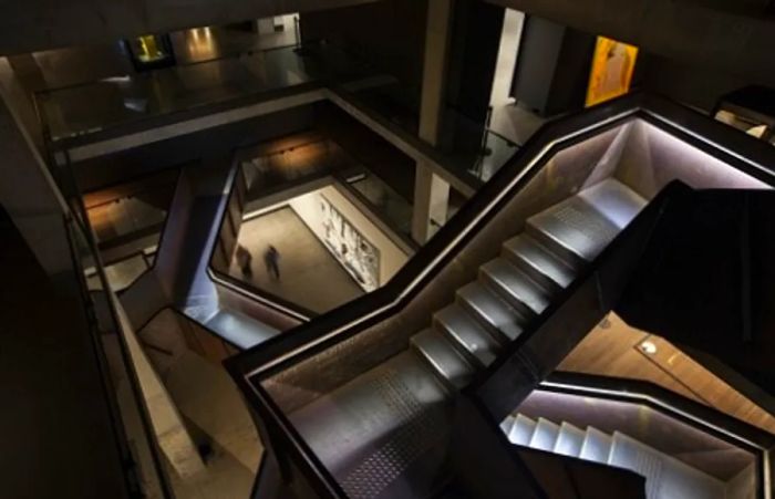 corten steel stairwell and the surrounding gallery in an art museum