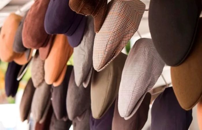 a collection of coppola caps displayed on a market stand in Palermo, Italy