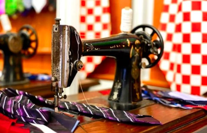 a vintage sewing machine adorned with neckties