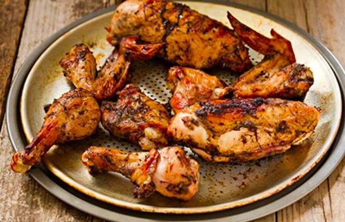 Grilled Jamaican jerk chicken served on a platter