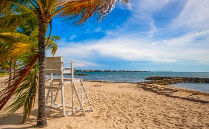 A white lifeguard station overlooking Saunders Beach in Nassau, Bahamas